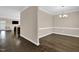 Elegant dining room with dark hardwood floors, decorative molding, and modern chandelier at 343 Brinkley Cir, Mebane, NC 27302