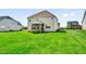 Back exterior view of home with well-manicured lawn and screened porch at 343 Brinkley Cir, Mebane, NC 27302
