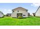 Back exterior view of home with well-manicured lawn and screened porch at 343 Brinkley Cir, Mebane, NC 27302