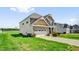 Attractive home with a two-car garage, well-kept lawn, and landscaping on a sunny day at 343 Brinkley Cir, Mebane, NC 27302