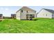 Back exterior view of home with well-manicured lawn and screened porch at 343 Brinkley Cir, Mebane, NC 27302