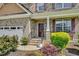 Welcoming front porch with detailed trim, brick facade, and a manicured landscape at 343 Brinkley Cir, Mebane, NC 27302