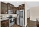 This kitchen features stainless steel appliances, granite countertops, and dark wood cabinets at 343 Brinkley Cir, Mebane, NC 27302