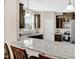 Well-lit kitchen with a gray countertop, dark wood cabinets, stainless steel appliances and pendant lighting at 343 Brinkley Cir, Mebane, NC 27302
