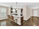 Stylish kitchen island with granite countertops, barstool seating, and modern pendant lighting at 343 Brinkley Cir, Mebane, NC 27302