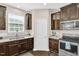 Spacious kitchen with stainless steel appliances, stone countertops, and dark wood cabinets at 343 Brinkley Cir, Mebane, NC 27302