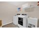 Modern laundry room equipped with new washer, dryer, and utility sink at 343 Brinkley Cir, Mebane, NC 27302