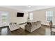 Spacious living room offers plenty of natural light and wood flooring at 343 Brinkley Cir, Mebane, NC 27302
