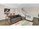 Open-concept living room view showcases a staircase, wood floors, and leads into the kitchen at 343 Brinkley Cir, Mebane, NC 27302