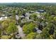 An aerial view showcases the community, its lush greenery and nearby commercial buildings at 3743 Yorktown Pl, Raleigh, NC 27609