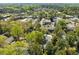 A high-angle aerial view shows residential area with lush trees and commercial buildings at 3743 Yorktown Pl, Raleigh, NC 27609