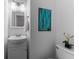 Cozy bathroom with a vanity, framed mirror, toilet and blue accent painting at 3743 Yorktown Pl, Raleigh, NC 27609