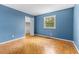 Bedroom with wood floors and a window at 3743 Yorktown Pl, Raleigh, NC 27609