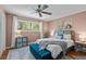 Comfortable bedroom with soft pink walls, a large window, and stylish decor at 3743 Yorktown Pl, Raleigh, NC 27609