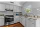 Bright kitchen with white cabinets, subway tile, stainless appliances and hardwood floors at 3743 Yorktown Pl, Raleigh, NC 27609