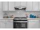 Well-lit kitchen featuring white subway tile backsplash, granite countertops, and stainless steel appliances at 3743 Yorktown Pl, Raleigh, NC 27609