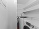 A laundry room featuring a washing machine and dryer with shelving above, perfect for organization at 3743 Yorktown Pl, Raleigh, NC 27609
