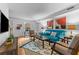Cozy living room with a blue couch, patterned rug, and contemporary artwork at 3743 Yorktown Pl, Raleigh, NC 27609