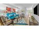 Bright living room featuring a comfortable blue sofa and stylish decor at 3743 Yorktown Pl, Raleigh, NC 27609