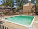 Community pool surrounded by a brick fence and sun loungers for relaxation and leisure at 3743 Yorktown Pl, Raleigh, NC 27609