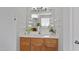 Bright bathroom features a wood vanity, white countertop, and large mirror at 3905 Joe And Ruth Lee Dr, Raleigh, NC 27610
