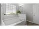 Bright bathroom boasts a soaking tub and a large window for natural light at 3905 Joe And Ruth Lee Dr, Raleigh, NC 27610