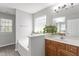 Bathroom features an oversized mirror and separate soaking tub with natural light at 3905 Joe And Ruth Lee Dr, Raleigh, NC 27610