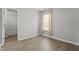 Empty bedroom boasts LVP flooring, a window with curtains, and a walk-in closet at 3905 Joe And Ruth Lee Dr, Raleigh, NC 27610