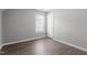 Bright, airy bedroom with grey walls, wood-look floors, and a window for natural light at 3905 Joe And Ruth Lee Dr, Raleigh, NC 27610