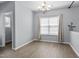 Bright dining room featuring wood flooring, elegant chandelier, and natural light at 3905 Joe And Ruth Lee Dr, Raleigh, NC 27610