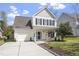 Charming two-story home with a manicured lawn, attached garage, and inviting front porch at 3905 Joe And Ruth Lee Dr, Raleigh, NC 27610
