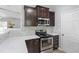 The kitchen boasts stainless appliances, dark wood cabinets, granite counters, and modern fixtures at 3905 Joe And Ruth Lee Dr, Raleigh, NC 27610