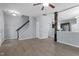The spacious living room features wood-look floors, a staircase, and a view into the kitchen at 3905 Joe And Ruth Lee Dr, Raleigh, NC 27610