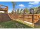Fenced backyard with grass, a wooden fence and gate, offering privacy and security at 404 Cotton Brook Dr, Fuquay Varina, NC 27526