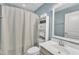 Cozy bathroom with blue walls, a shower with a curtain, and a framed mirror at 404 Cotton Brook Dr, Fuquay Varina, NC 27526