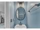 Stylish powder room boasts a unique mirror, a modern sink, and powder blue walls at 404 Cotton Brook Dr, Fuquay Varina, NC 27526