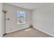 Empty bedroom with carpet, a window, a floor lamp, and white walls at 404 Cotton Brook Dr, Fuquay Varina, NC 27526