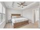 Bright bedroom with a tray ceiling, ceiling fan, and a king-sized bed at 404 Cotton Brook Dr, Fuquay Varina, NC 27526