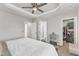 Bedroom features a ceiling fan, carpet, walk-in closet, and access to the bathroom at 404 Cotton Brook Dr, Fuquay Varina, NC 27526