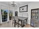 Dining room features sliding glass door and a table with seating below decorative lighting at 404 Cotton Brook Dr, Fuquay Varina, NC 27526