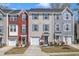 Charming townhouse exterior with colorful siding, attached garage, and well-maintained landscaping at 404 Cotton Brook Dr, Fuquay Varina, NC 27526