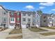 Charming townhouse exterior featuring colorful siding, attached garage, and landscaped front yard at 404 Cotton Brook Dr, Fuquay Varina, NC 27526