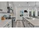 Modern kitchen with stainless steel appliances, white subway tile backsplash, and island sink at 404 Cotton Brook Dr, Fuquay Varina, NC 27526