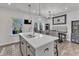 Open kitchen with island sink, granite countertops, stainless appliances, and view to the deck at 404 Cotton Brook Dr, Fuquay Varina, NC 27526