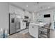 Bright kitchen with white cabinets, a stainless steel refrigerator, and a cozy breakfast bar for casual dining at 404 Cotton Brook Dr, Fuquay Varina, NC 27526