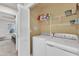 Convenient laundry room with modern appliances and storage shelves, located near the bedroom at 404 Cotton Brook Dr, Fuquay Varina, NC 27526