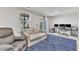 Functional living room with comfortable seating, computer setup, and blue rug at 404 Cotton Brook Dr, Fuquay Varina, NC 27526