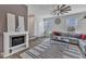 Comfortable living room features a fireplace, ceiling fan, and ample natural light for a relaxing experience at 404 Cotton Brook Dr, Fuquay Varina, NC 27526