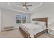 Main bedroom features trey ceiling, a large window and a king bed with a bench at 404 Cotton Brook Dr, Fuquay Varina, NC 27526