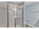 Bathroom featuring a glass-enclosed shower with tile surround and modern fixtures at 404 Cotton Brook Dr, Fuquay Varina, NC 27526